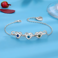Personalized engraved heart bracelet with custom name and birthstone, featuring a delicate chain in silver